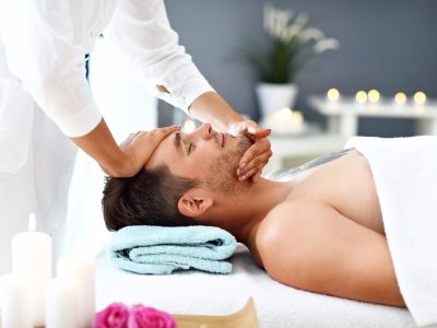 Picture of handsome man having massage in spa salon